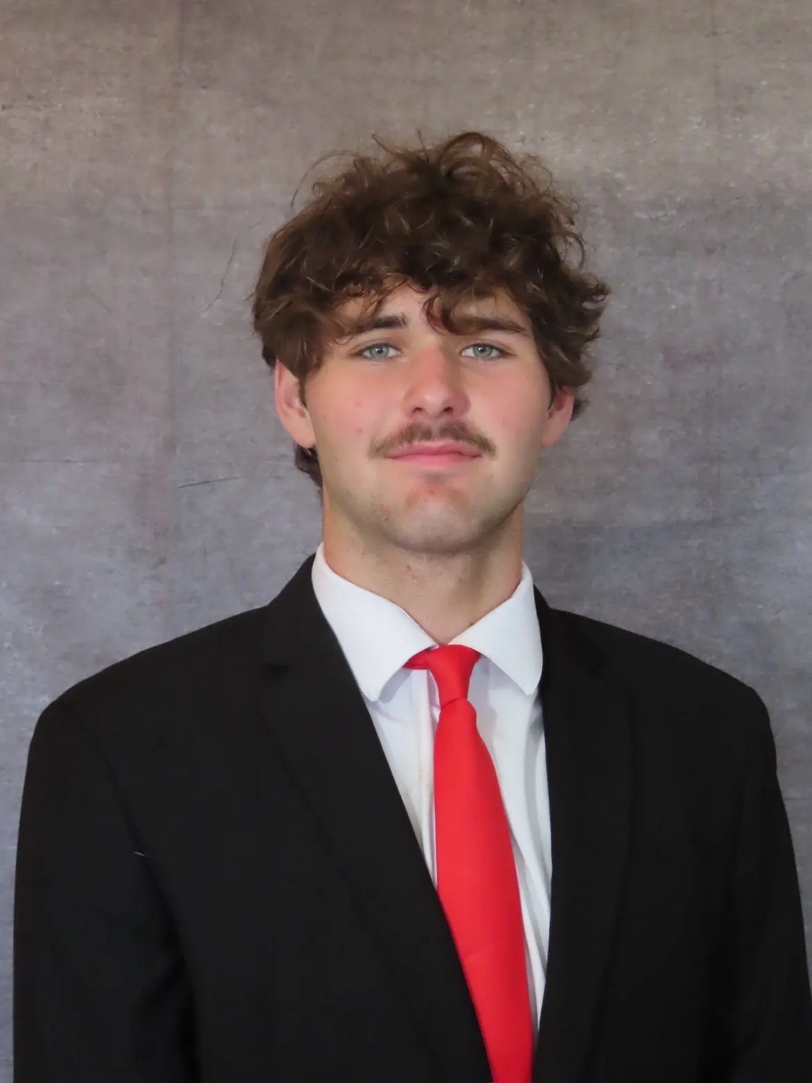 Tillman Rexrode in a suit and red tie